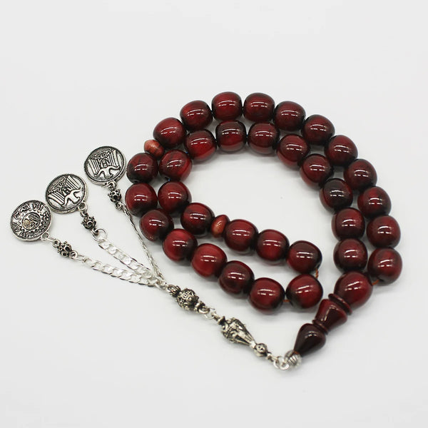 Aged Turkish musk rosary in cherry color mixed with black, the size of a medium bead, woven with double propylene thread for greater durability and with a corkouche made of a mixture of antimony and metal.