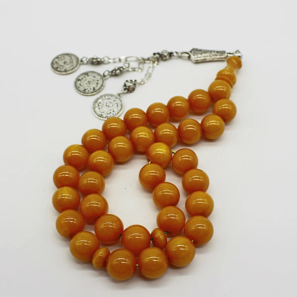 Aged Turkish musk rosary in light honey color, medium size bead, woven with double propylene thread for greater durability and with a karakosha made of a mixture of antimony and metal.