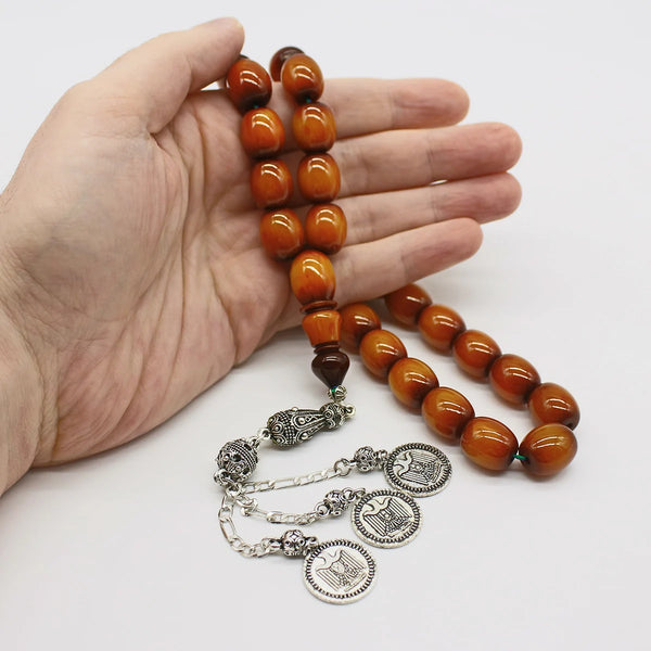 Aged Turkish musk rosary in honey color, wavy black, large bead size, woven with double propylene thread for greater durability and with a corkouche made of a mixture of antimony and metal.