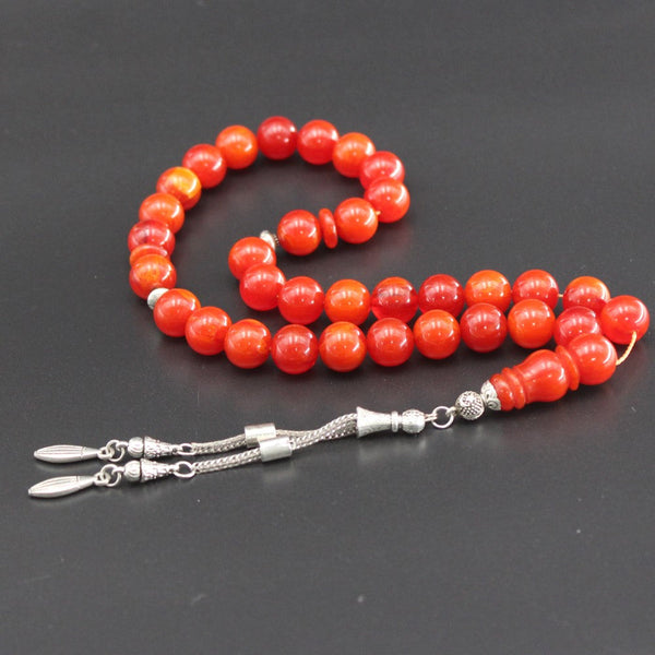 A beautiful peach-red sandalous rosary with a medium bead woven with strong fluorocarbon thread and a crochet made of a mixture of antimony and metal.