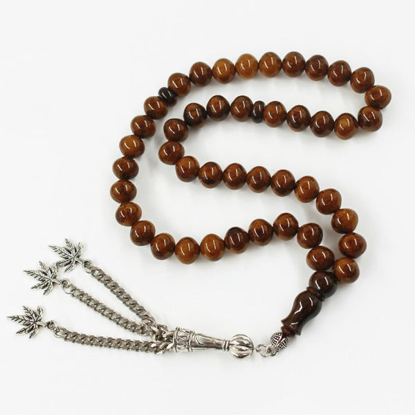 Aged musky sandalous rosary in a beautiful olive color, a soft bead woven with durable propylene thread and a crochet made of a mixture of antimony and metal.