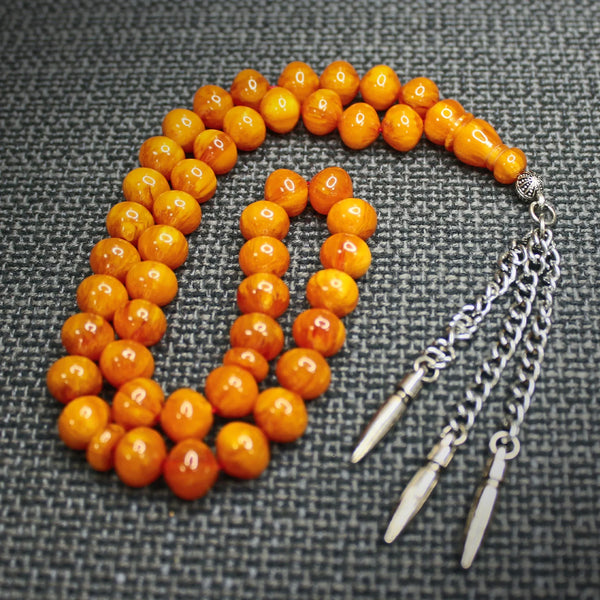 Aged musky sandalous rosary in a distinctive honey color, a soft bead woven with durable propylene thread and a crochet made of a mixture of antimony and metal.